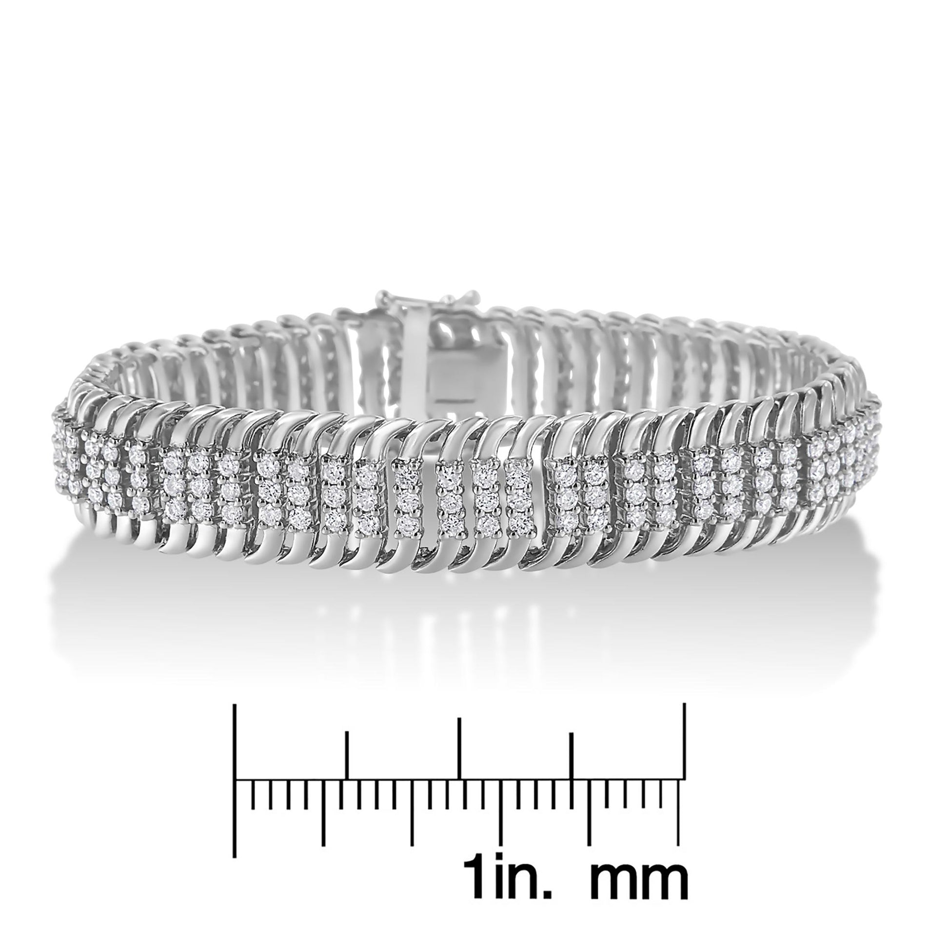 White metal bracelet with rows of round white gemstones in prong settings, shown from a front angle, placed on a scale for size reference.