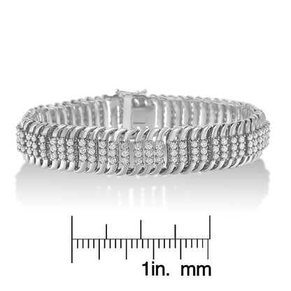 White metal bracelet with rows of round white gemstones in prong settings, shown from a front angle, placed on a scale for size reference.