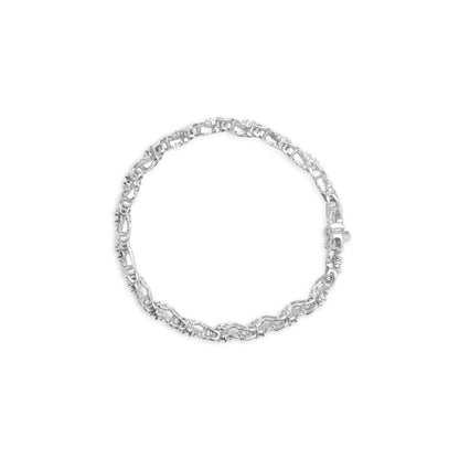 Top-down view of a white metal bracelet featuring round prong-set white gemstones and baguette channel-set white gemstones arranged in an interlocking chain design.