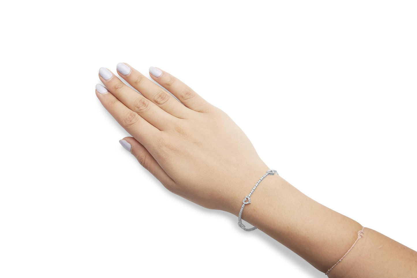 White metal bracelet with round white gemstones in prong settings forming heart shapes, shown on a model's wrist from a top-down angle.