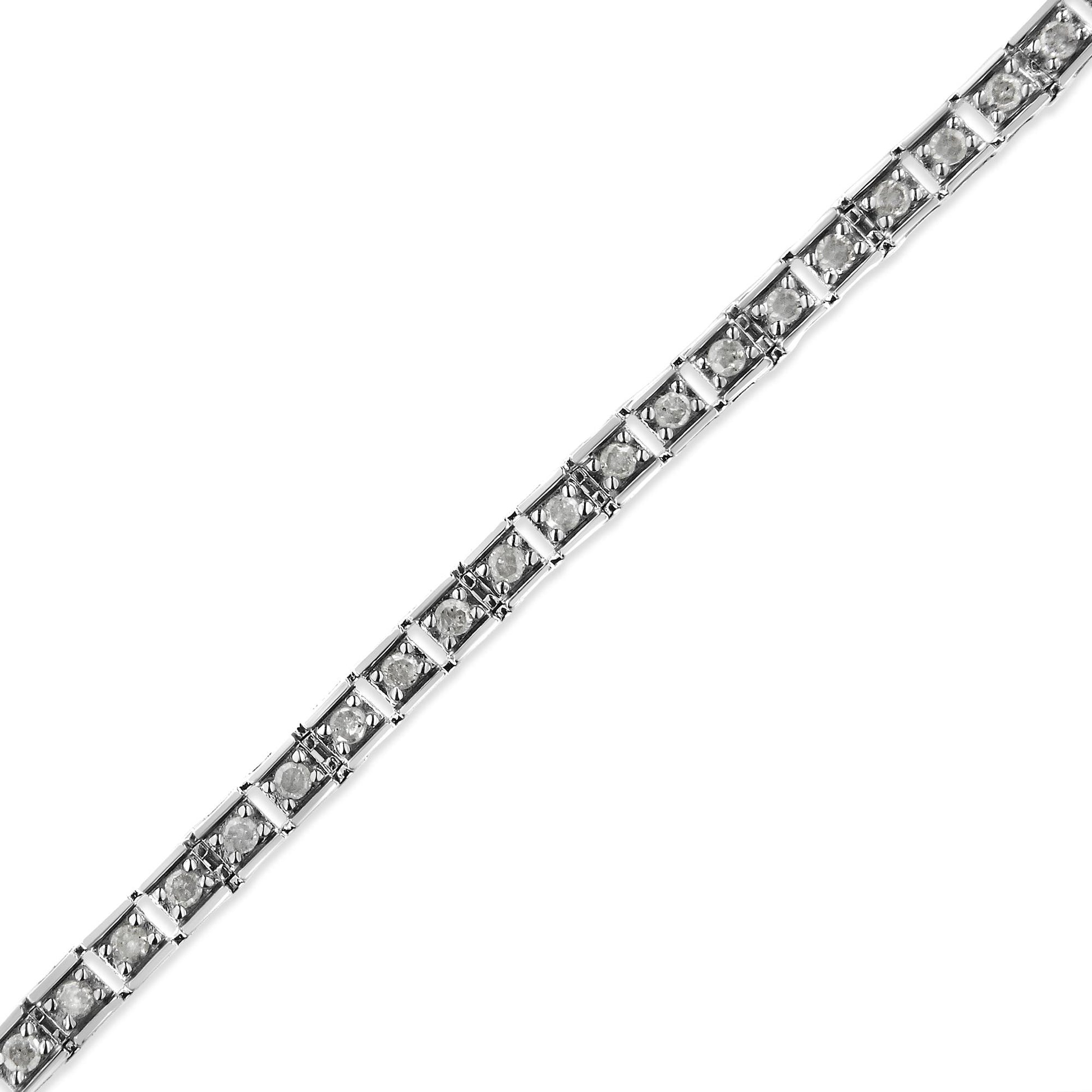Diagonal close-up image of a white metal bracelet with round white gemstones in prong settings.