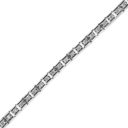 Diagonal close-up image of a white metal bracelet with round white gemstones in prong settings.