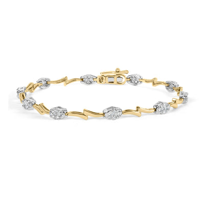 Bracelet with alternating yellow and white metal zigzag and cluster designs set with round white gemstones, shown in a close-up angled view.
