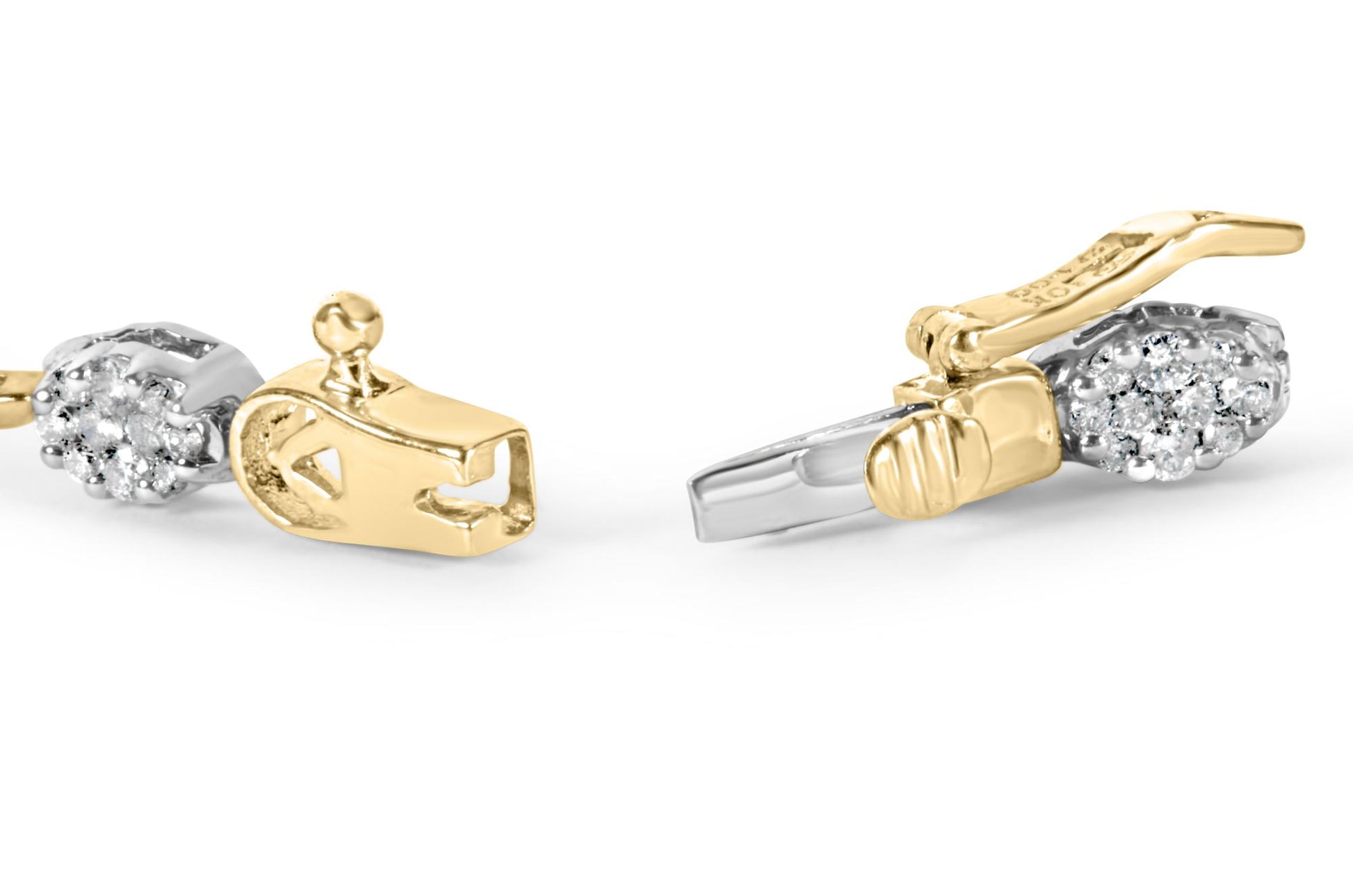 Close-up front angle of a yellow and white metal bracelet clasp featuring clusters of round white gemstones in a prong setting.