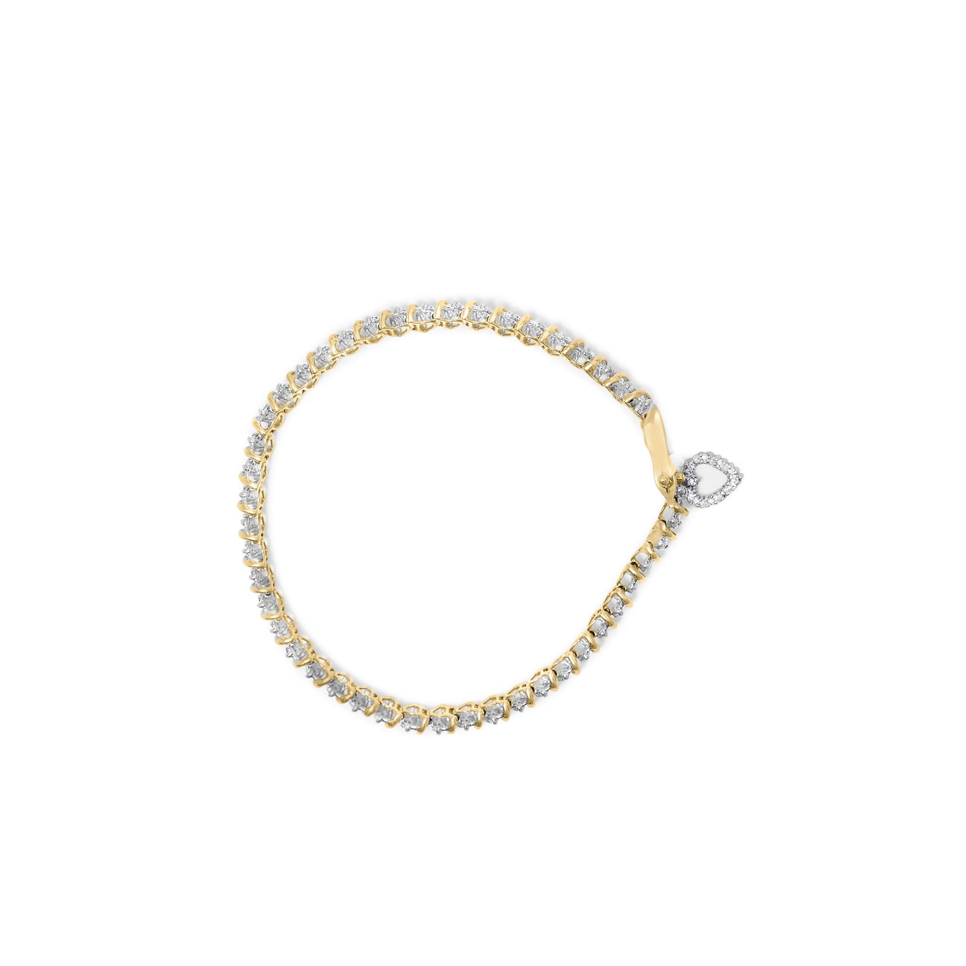 Yellow metal bracelet with round white gemstones in prong settings and a heart-shaped gemstone clasp, shown from a top-down angle on a white background.