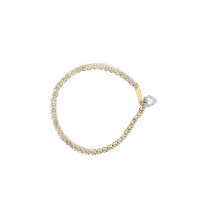 Yellow metal bracelet with round white gemstones in prong settings and a heart-shaped gemstone clasp, shown from a top-down angle on a white background.