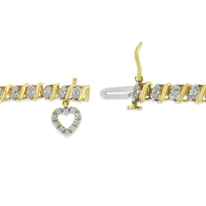 Close-up top view of a yellow bracelet with white round gemstones in prong settings and a heart-shaped charm made of white gemstones, shown unclasped on a white background.