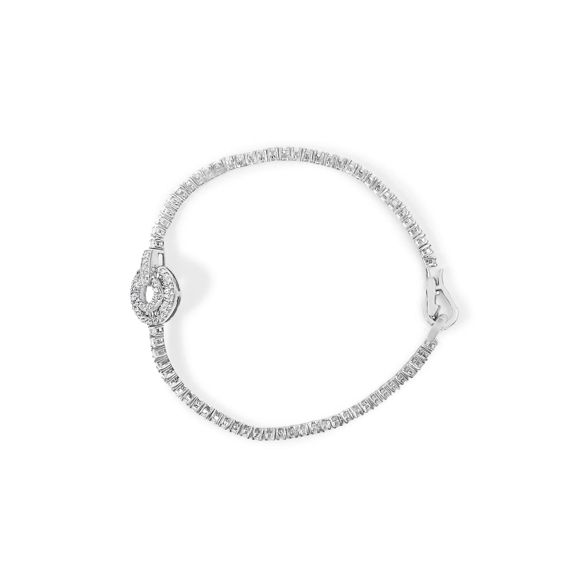 White bracelet with round and baguette white gemstones, shown from above on a white background.