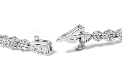 Close-up, angled view of a white metal bracelet with round white gemstones in prong settings and baguette-shaped white gemstones in channel settings, showing the clasp.