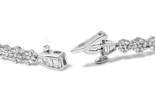 Close-up, angled view of a white metal bracelet with round white gemstones in prong settings and baguette-shaped white gemstones in channel settings, showing the clasp.