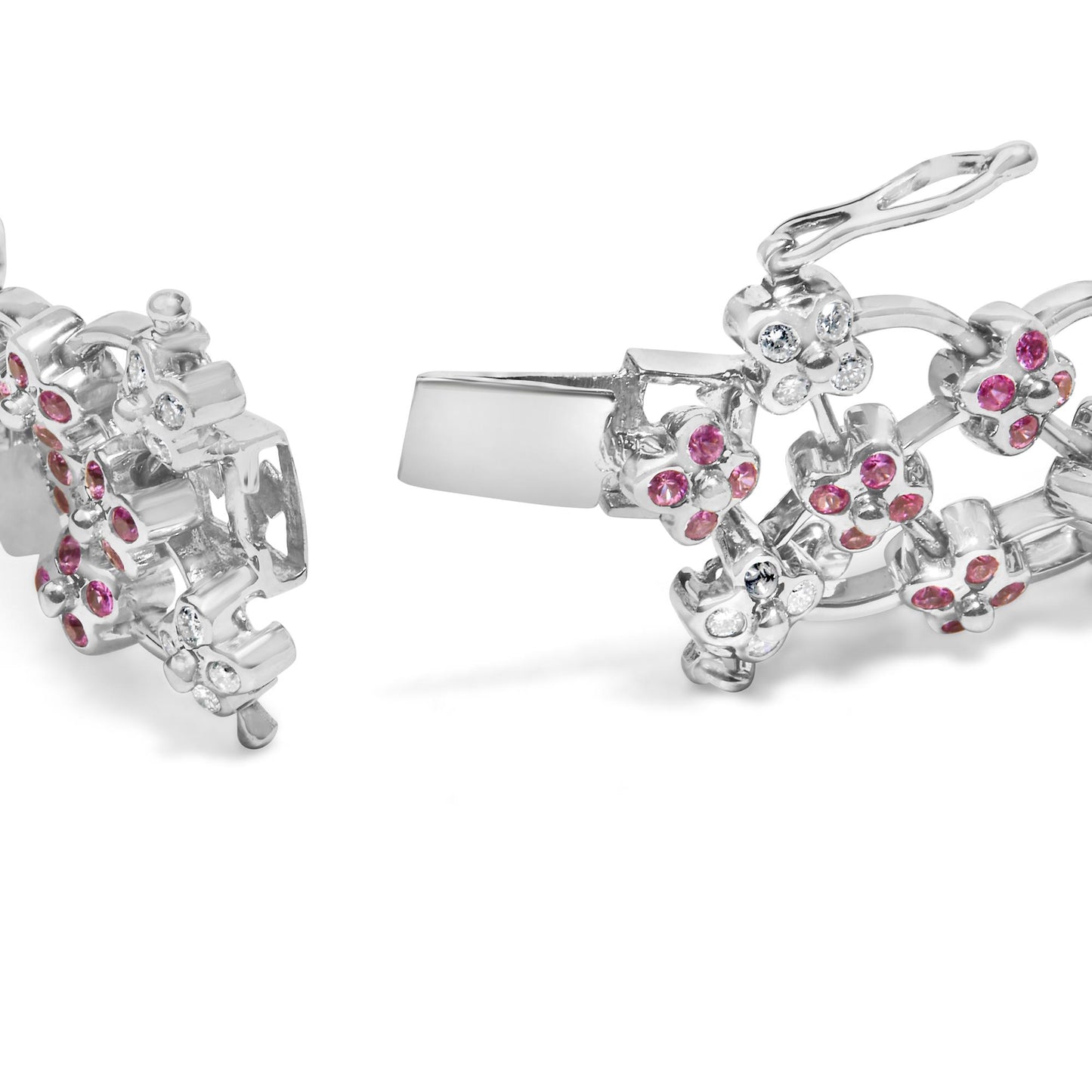 Close-up angled view of a white metal bracelet with floral designs showcasing round pink and white gemstones in bezel settings, with the clasp open.