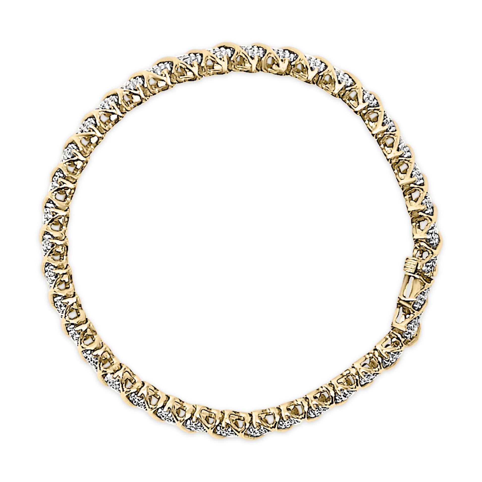 Close-up top angle of a yellow metal bracelet featuring round white gemstones in prong settings along its length.