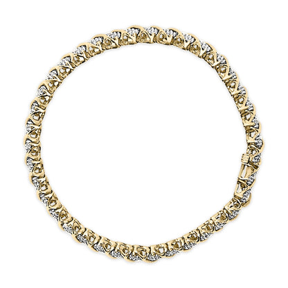 Close-up top angle of a yellow metal bracelet featuring round white gemstones in prong settings along its length.