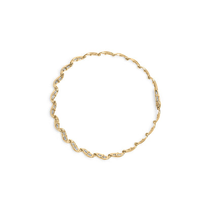 Top-down view of a yellow bracelet featuring a twisted design with white baguette-shaped gemstones in a channel setting.
