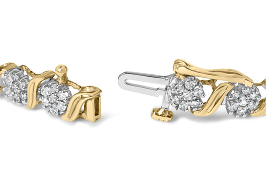 Close-up, angled shot of a yellow metal bracelet with clusters of white round gemstones in prong settings and a visible clasp mechanism.