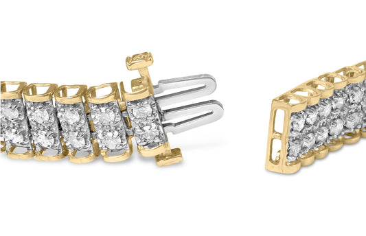 Close-up angle of a yellow metal bracelet with two rows of white round gemstones set in prongs, showing the clasp mechanism.