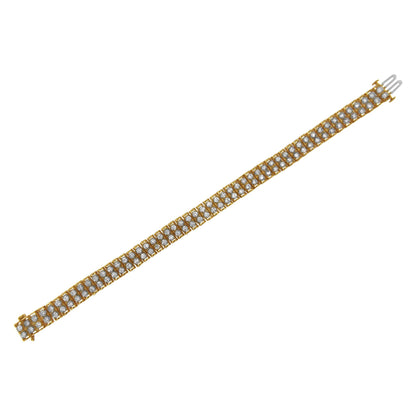 Diagonal top-down view of a yellow metal bracelet featuring multiple rows of round white gemstones in prong settings.