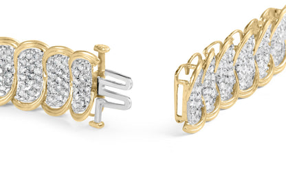 Close-up front angle of a yellow metal bracelet with white round gemstones in prong settings and a clasp visible.