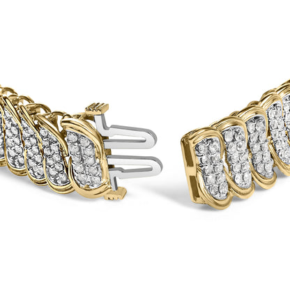 Close-up angle of a yellow metal bracelet featuring multiple clusters of round white gemstones in prong settings, showing the clasp ends.