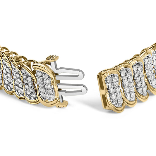Close-up angle of a yellow metal bracelet featuring multiple clusters of round white gemstones in prong settings, showing the clasp ends.