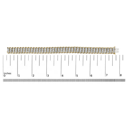 Yellow metal bracelet with multiple white round gemstones in prong settings, shown flat on a scale, photographed from a top-down angle.