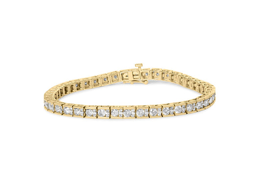 Yellow metal bracelet with round white gemstones in prong settings, shown from a slightly elevated front angle.