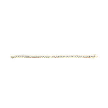 Yellow metal bracelet with white round gemstones in prong settings, shown in a flat lay from a top-down angle.