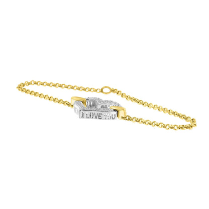 Bracelet photographed at a slight angle, featuring a yellow and white metal chain with a central rectangular white metal plate engraved with 'I LOVE YOU' and adorned with round white gemstones in a prong setting.