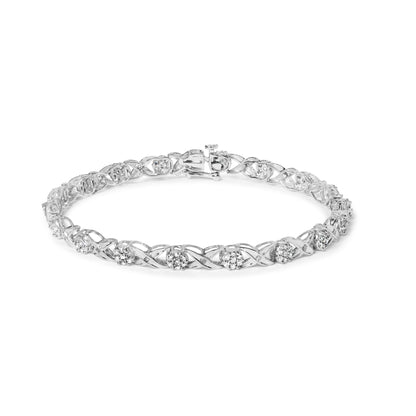 White metal bracelet with round prong-set white gemstones and channel-set baguette white gemstones, shown in a top front angle.