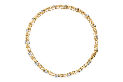 Top-down view of a white metal bracelet with round and baguette white gemstones set in alternating prong and channel settings.