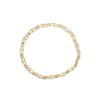 Top-down view of a yellow metal bracelet featuring round white gemstones in prong settings and baguette white gemstones in channel settings.