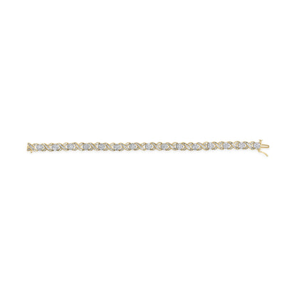 Straight-on shot of a yellow metal bracelet featuring alternating round white gemstones in prong settings and baguette-shaped white gemstones in channel settings.