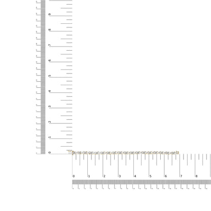 Yellow metal bracelet with round white gemstones in pave setting, displayed flat on a ruler for size reference, top-down angle.