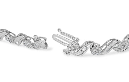 Close-up side angle of a white metal bracelet with round prong-set white gemstones and baguette channel-set white gemstones in a wave design shown unclasped.