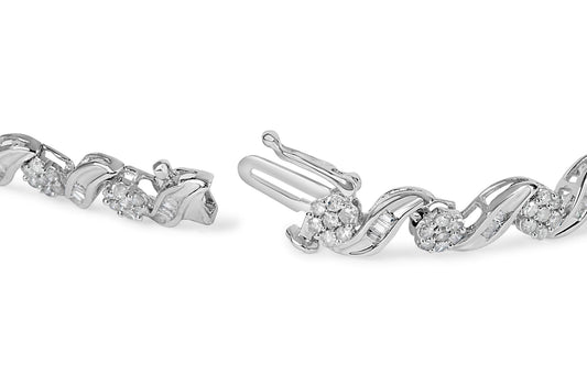 Close-up side angle of a white metal bracelet with round prong-set white gemstones and baguette channel-set white gemstones in a wave design shown unclasped.