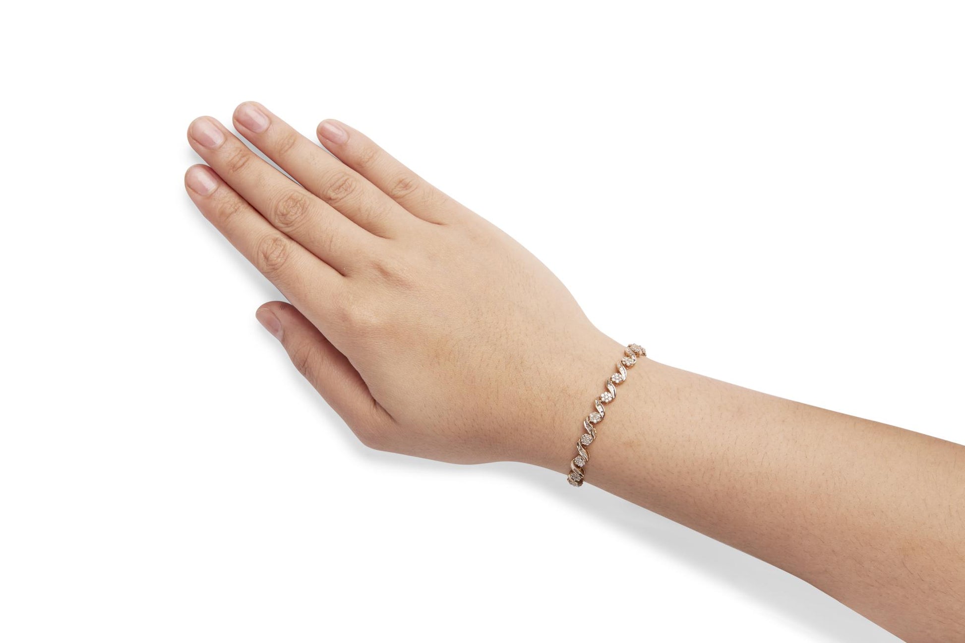 Yellow bracelet with round and baguette white gemstones in prong and channel settings, shown on a model's wrist at an angle.