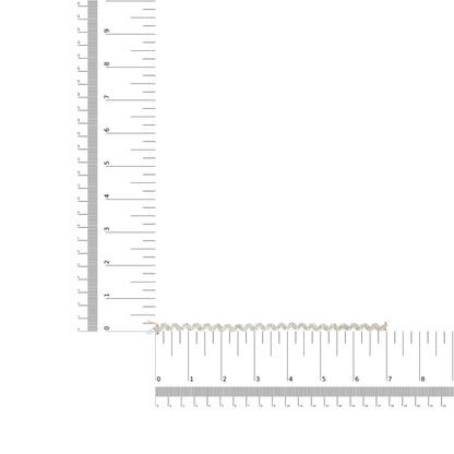Close-up top view of a yellow bracelet set with round and baguette white gemstones, displayed on a ruler for size reference.