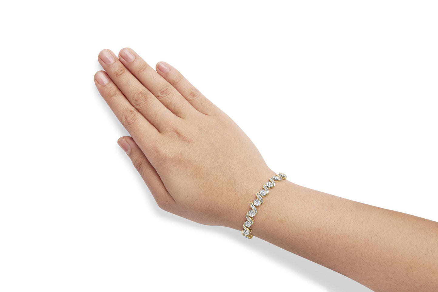 Yellow metal bracelet with round and baguette white gemstones, shown on a model's wrist, angled top-down.