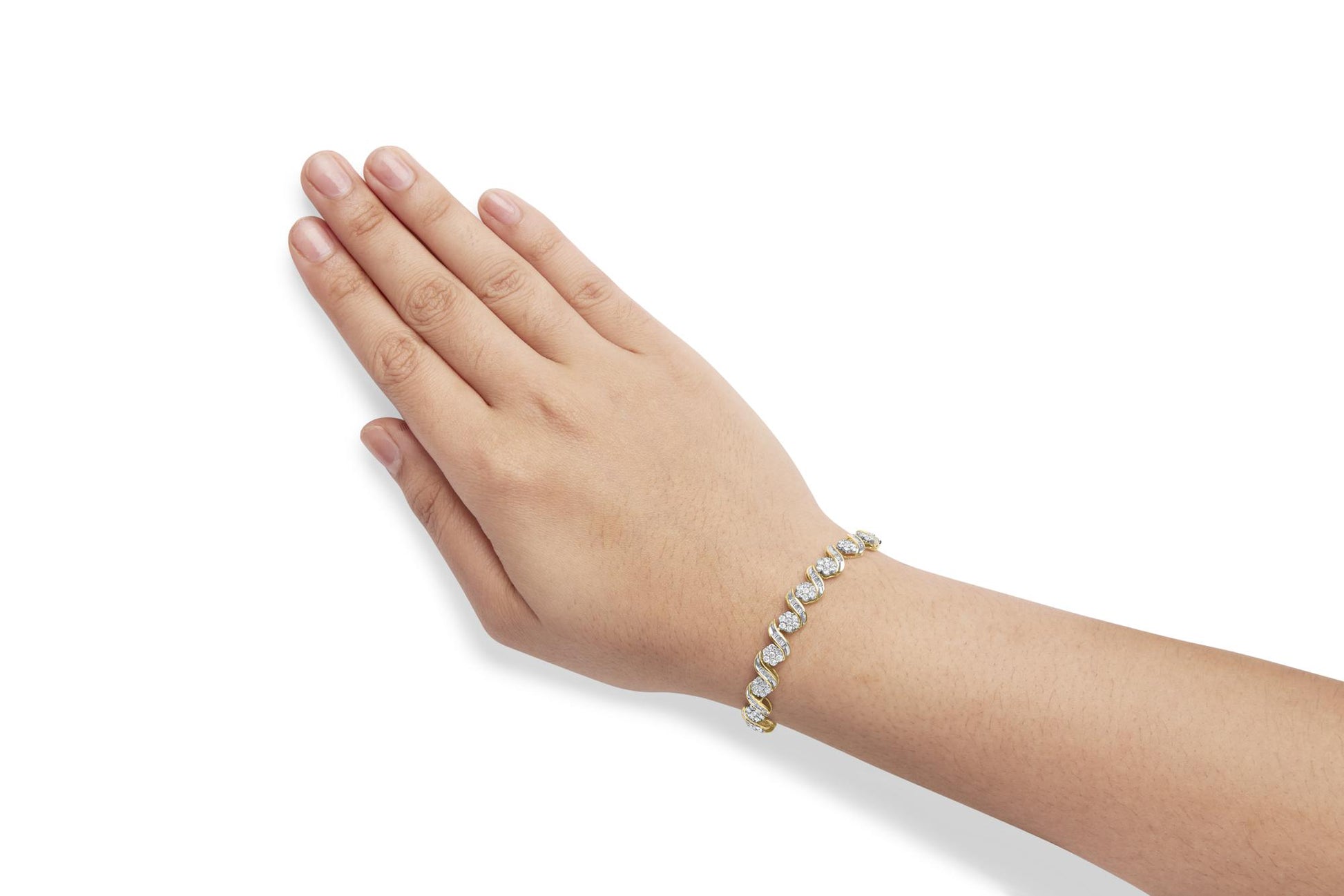 Yellow metal bracelet with round and baguette white gemstones, shown on a model's wrist, angled top-down.