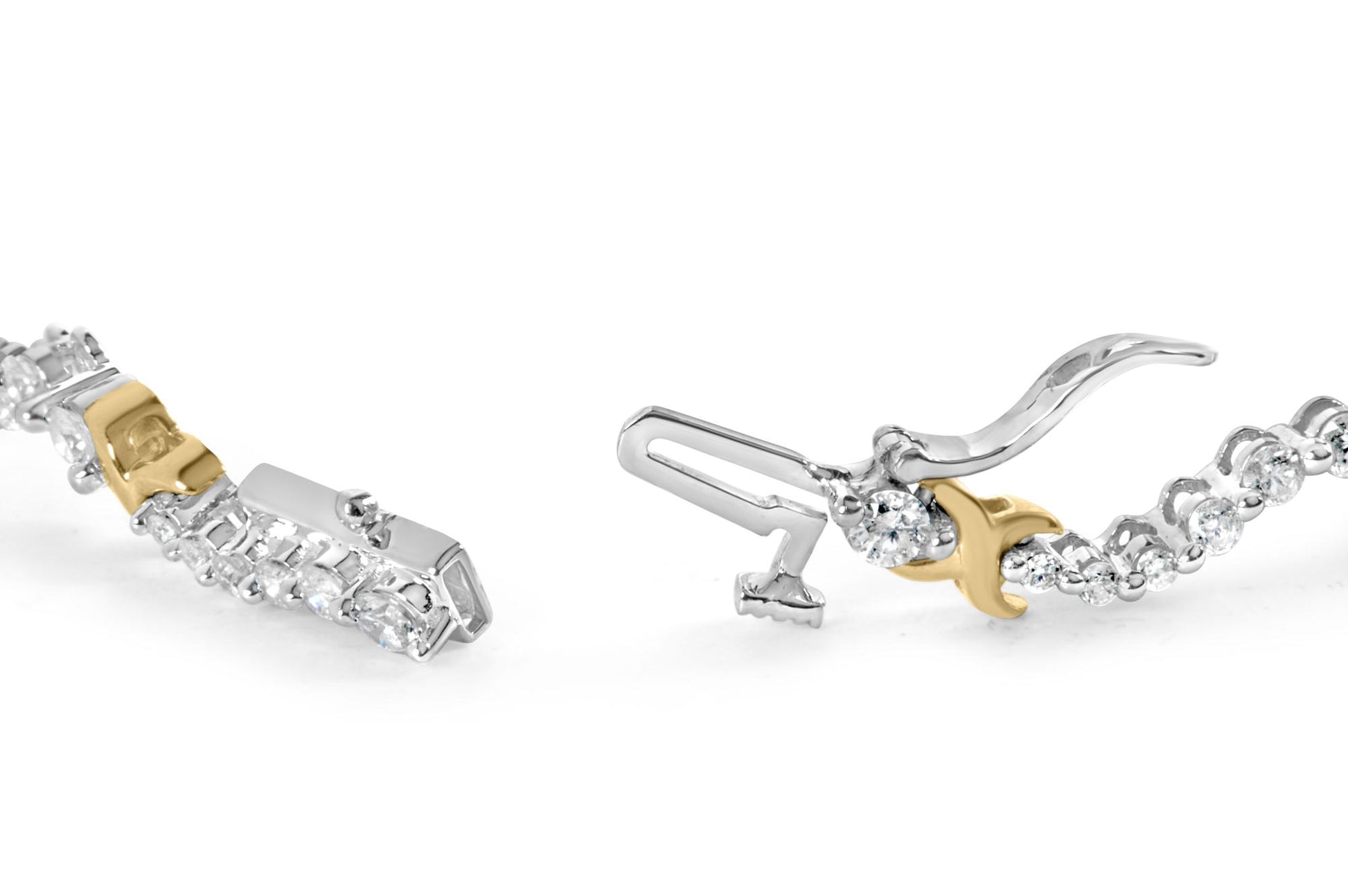 Close-up of an open yellow and white metal bracelet with round white gemstones, shown at an angle focusing on the clasp.