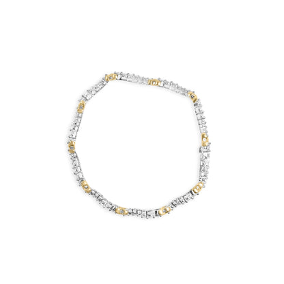 Top-down view of a yellow and white metal bracelet with alternating sections set with small round white gemstones.