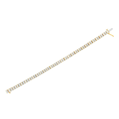 Yellow metal bracelet with alternating rows of white round gemstones in prong settings and white baguette gemstones in channel settings, shown from a top-down angle.