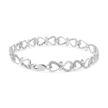 White metal bracelet with alternating heart and infinity links, some adorned with white gemstones, shown in a front angled view.