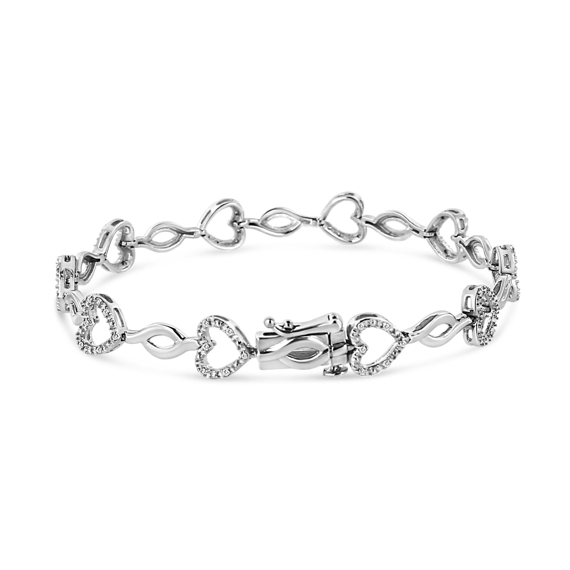 White metal bracelet with alternating heart shapes and infinity links, each heart adorned with round white gemstones in prong settings, shown from a front angle.