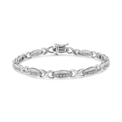 White metal bracelet with alternating oval and crisscross links, oval links set with small round white gemstones, shown from a front angle on a white background.