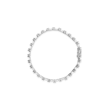 Top-down view of a white metal bracelet set with round white gemstones in prong settings forming a continuous circle.