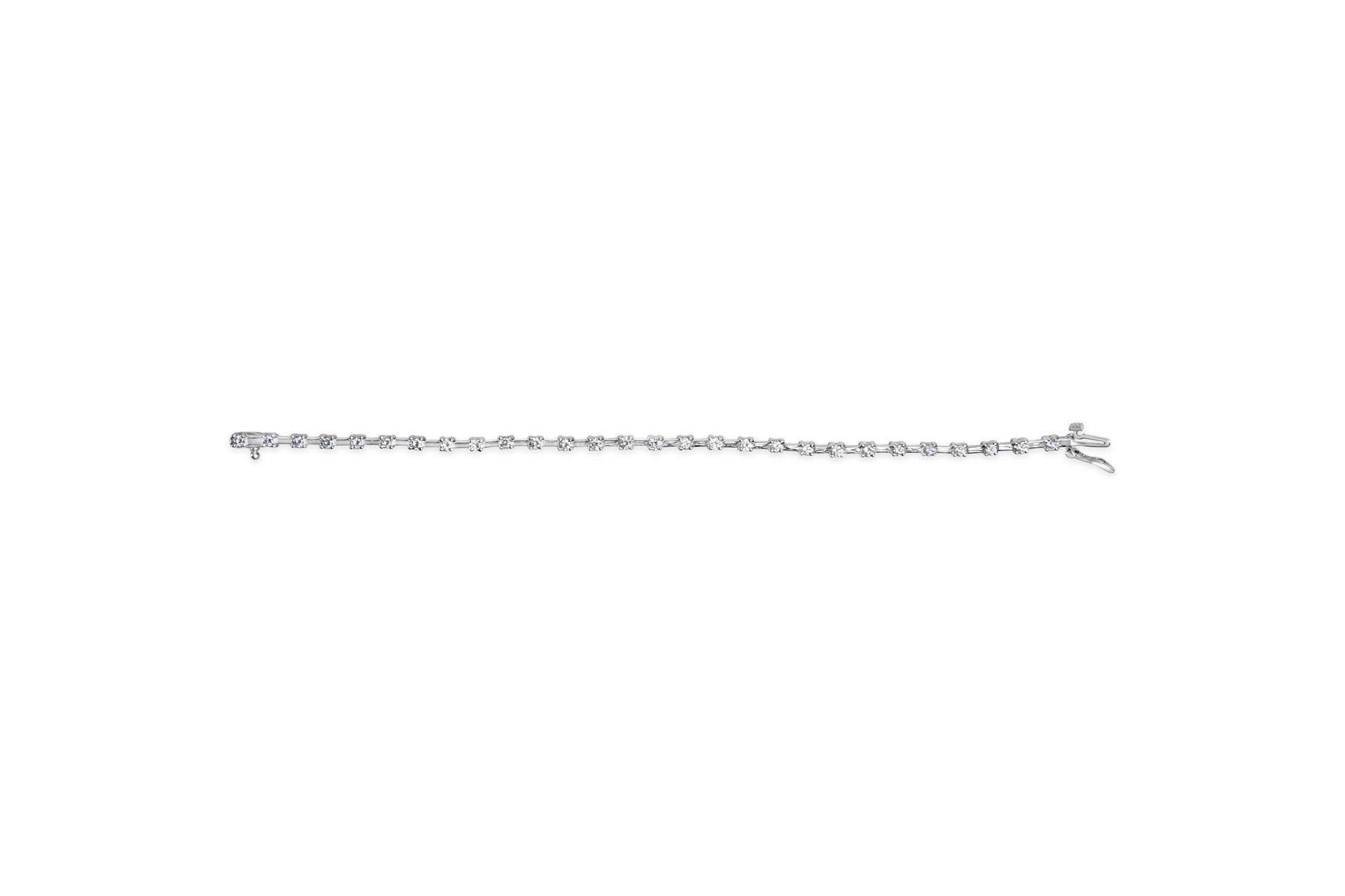 White metal bracelet with prong-set round white gemstones, shown from a top-down angle on a white background.