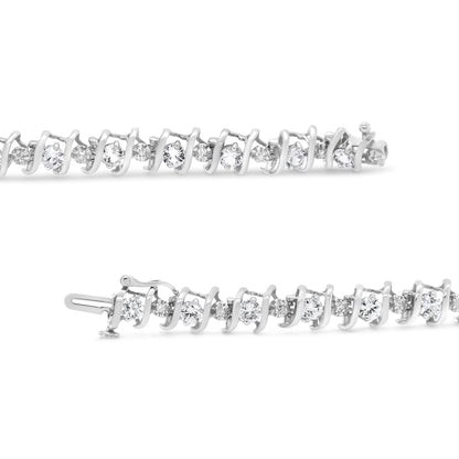 Close-up side view of a white metal bracelet featuring alternating round white gemstones and red gemstones in prong settings, laid flat on a white background.