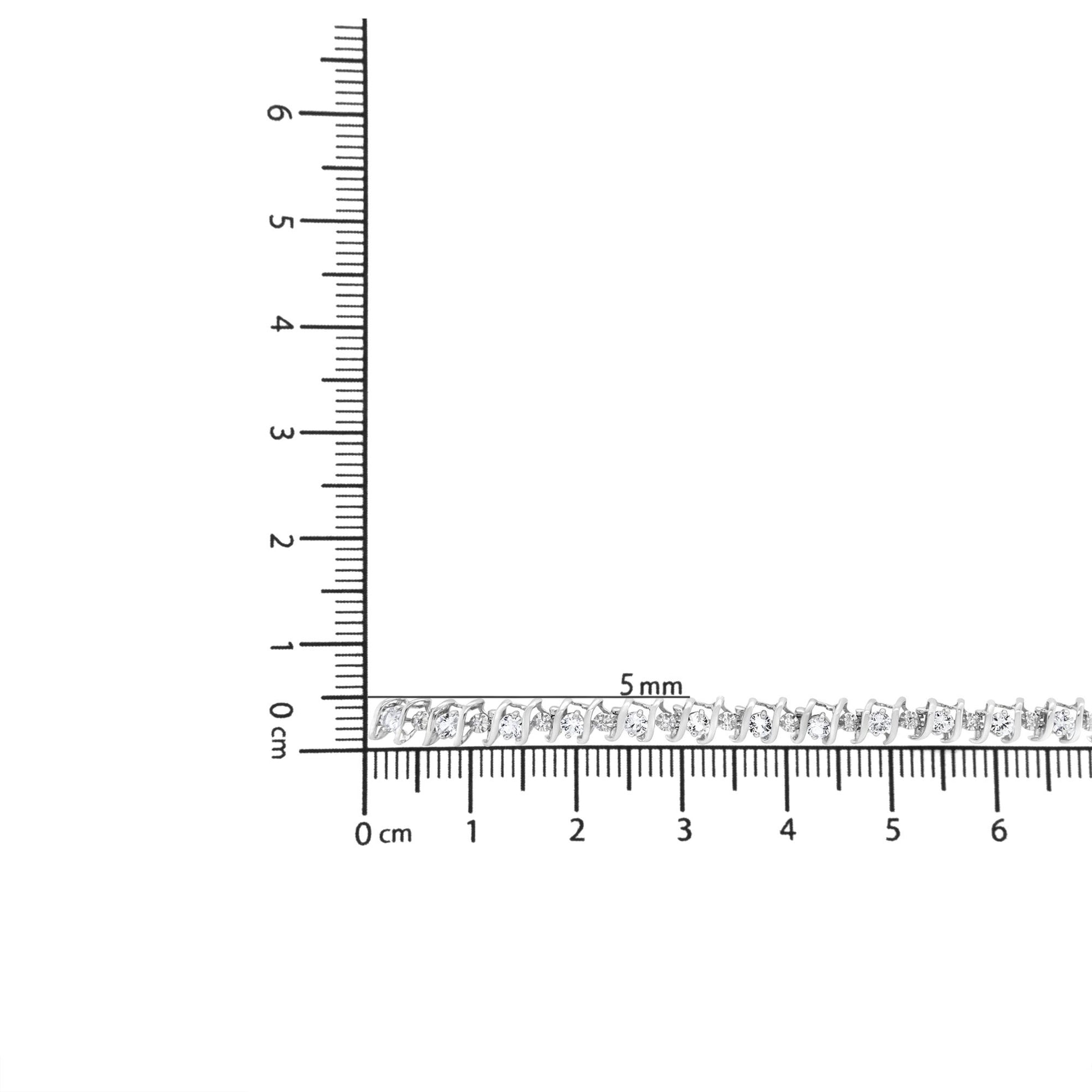 Close-up side angle of a white metal bracelet with alternating round white gemstones and prong settings placed on a ruler for size reference.