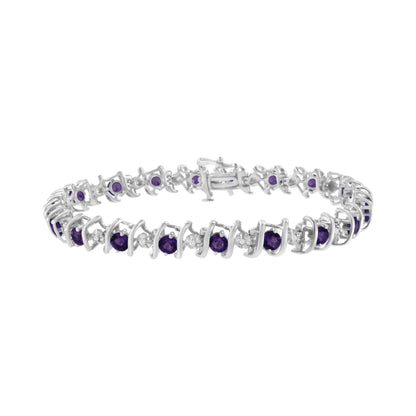 White metal bracelet with alternating round purple and white gemstones in prong settings, shown in a front angle view.